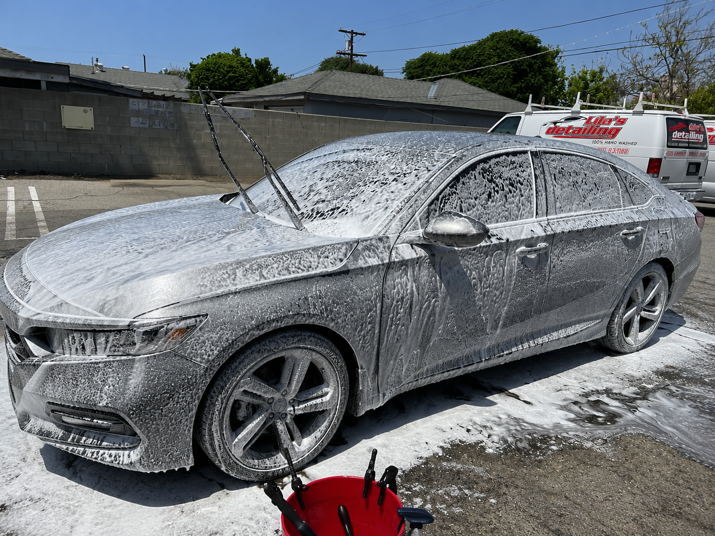Sedan foam wash in progress with detailing van